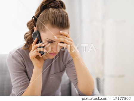 Stressed young woman talking cell phone 17177863