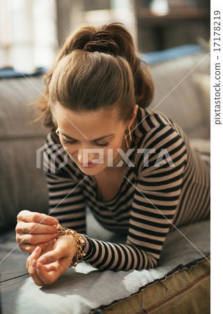 Young woman laying on divan in loft apartment Young woman laying on divan in loft apartment 17178219