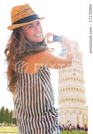 Happy young woman taking photo of leaning tower of pisa, tuscany 17178864
