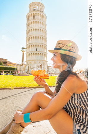 Happy young woman eating pizza in front of leaning tower of pisa Happy young woman eating pizza in front of leaning tower of pisa 17178876