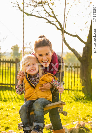 Portrait of smiling mother and child on swing Portrait of smiling mother and child on swing 17178894