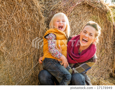 Portrait of smiling mother and child near haystack Portrait of smiling mother and child near haystack 17178949
