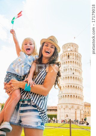 Happy mother and baby girl with italian flag in front of leaning Happy mother and baby girl with italian flag in front of leaning 17179018