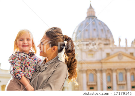 Portrait of happy mother and baby girl in front of basilica di s 17179145