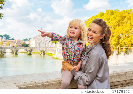 Happy mother and baby girl pointing while on bridge ponte umbert Happy mother and baby girl pointing while on bridge ponte umbert 17179162