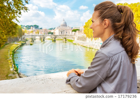 Young woman looking into distance while on bridge with view on b 17179236