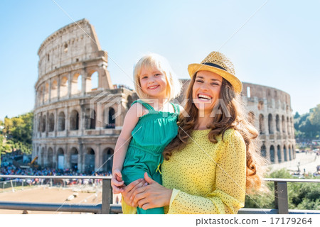 Portrait of happy mother and baby girl in front of colosseum in 17179264