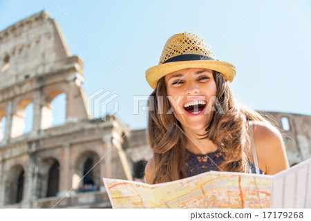 Portrait of happy young woman with map in front of colosseum in Portrait of happy young woman with map in front of colosseum in 17179268
