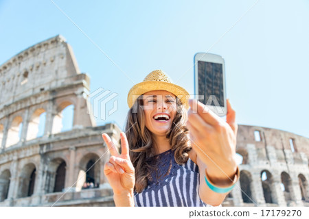 Happy young woman making selfie in front of colosseum in rome, i Happy young woman making selfie in front of colosseum in rome, i 17179270