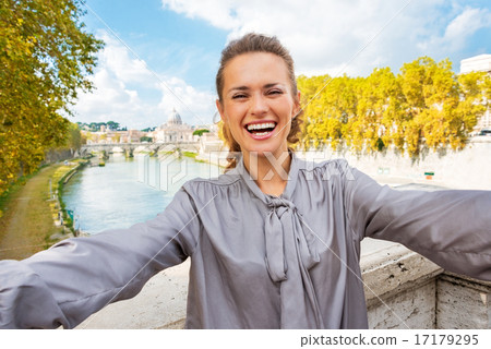 Smiling young woman making selfie on bridge ponte umberto I with Smiling young woman making selfie on bridge ponte umberto I with 17179295