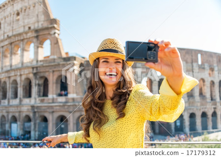 Happy young woman making selfie in front of colosseum in rome, i Happy young woman making selfie in front of colosseum in rome, i 17179312