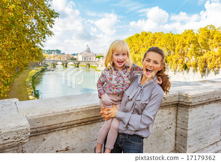 Portrait of happy mother and baby girl on bridge ponte umberto I 17179362