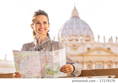 Happy young woman with map on piazza san pietro in vatican city 17179376