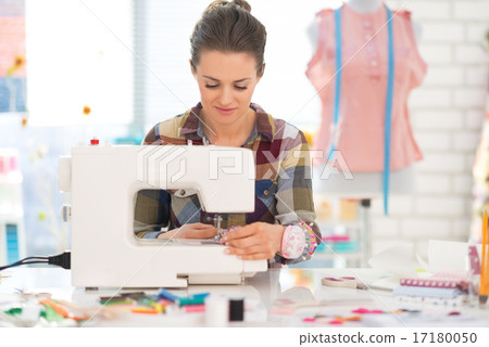 Seamstress sewing in studio Seamstress sewing in studio 17180050