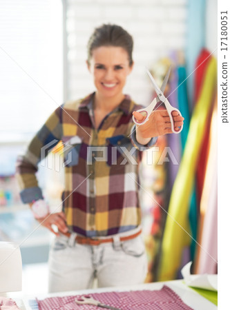 Closeup on happy tailor woman showing scissors Closeup on happy tailor woman showing scissors 17180051