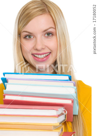 Happy student girl holding stack of books Happy student girl holding stack of books 17180052