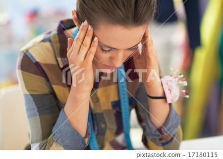 Portrait of stressed tailor woman at work 17180115