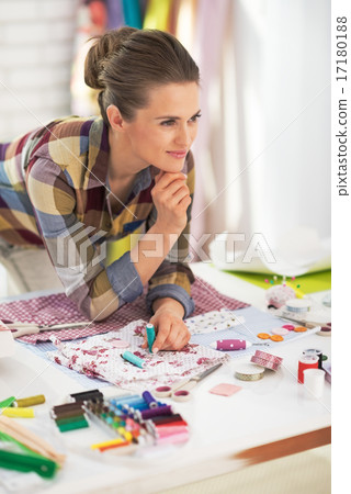 Portrait of thoughtful needlewoman in office Portrait of thoughtful needlewoman in office 17180188