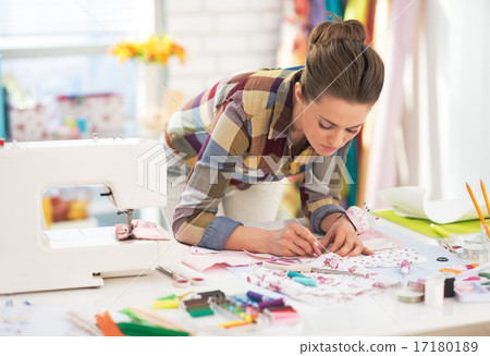 Dressmaker woman at work in studio Dressmaker woman at work in studio 17180189