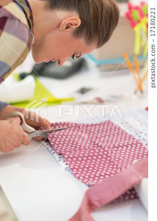 Seamstress cutting fabric 17180221