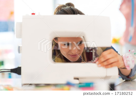Seamstress working with sewing machine Seamstress working with sewing machine 17180252