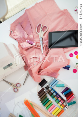 Closeup on seamstress table with tablet pc Closeup on seamstress table with tablet pc 17180253