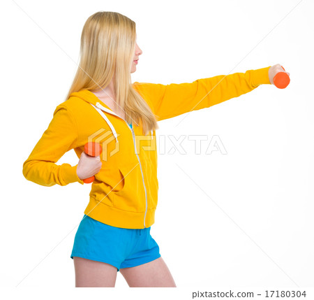 Teenager girl making exercise with dumbbells 17180304