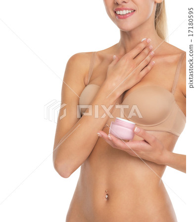Closeup on young woman in lingerie applying creme on neck Closeup on young woman in lingerie applying creme on neck 17180595