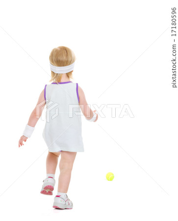 Baby running for tennis ball . rear view Baby running for tennis ball . rear view 17180596