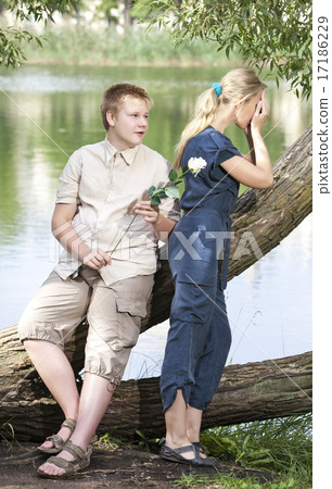 guy and girl on the nature near lake, reconciliati 17186229