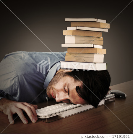 Composite image of businessman sleeping with his head on the key 17191961
