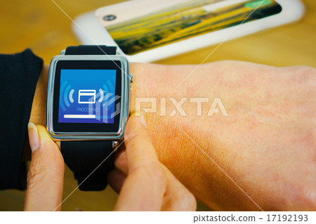 Composite image of businesswoman with smart watch on wrist 17192193
