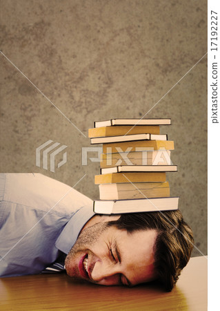 Composite image of casual businessman sleeping at his desk 17192227