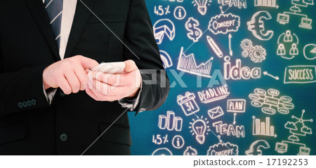Composite image of businessman sending a text message 17192253