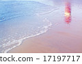lighthouse reflection among sea waves on beach 17197717