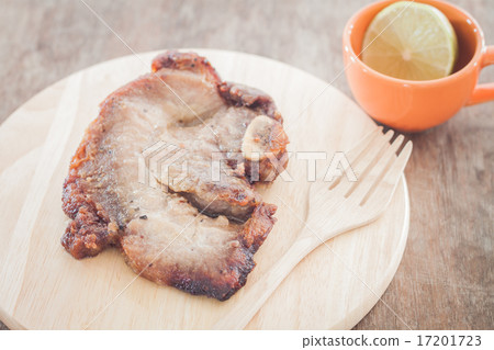 Pork steak on wooden plate Pork steak on wooden plate 17201723