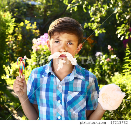 boy with cotton candy moustache on the summer background boy with cotton candy moustache on the summer background 17215782