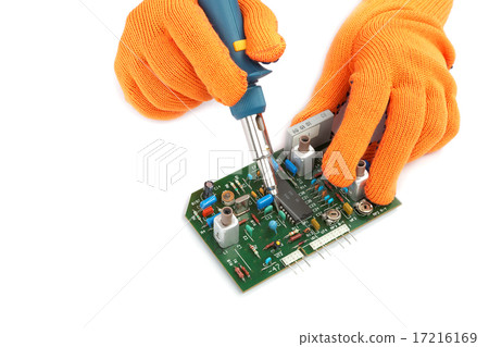 Soldering iron in hand and electric board. 17216169