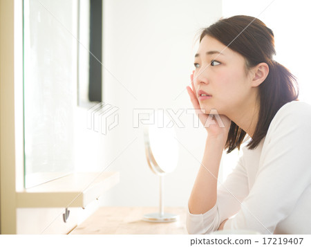 A young lady looking at a beauty mirror 17219407