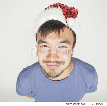 funy exotical asian Santa claus in new years red hat smiling 17219586