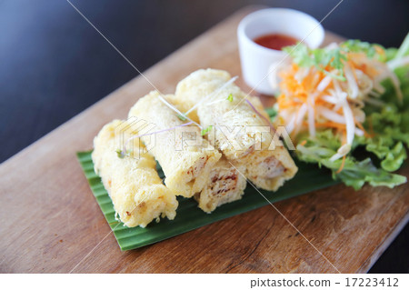 Spring roll on wood background Spring roll on wood background 17223412