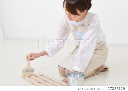 A woman painting a brush with a brush A woman painting a brush with a brush 17227129