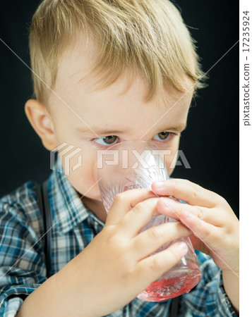 kid boy drinking juice. Studio photo kid boy drinking juice. Studio photo 17235924
