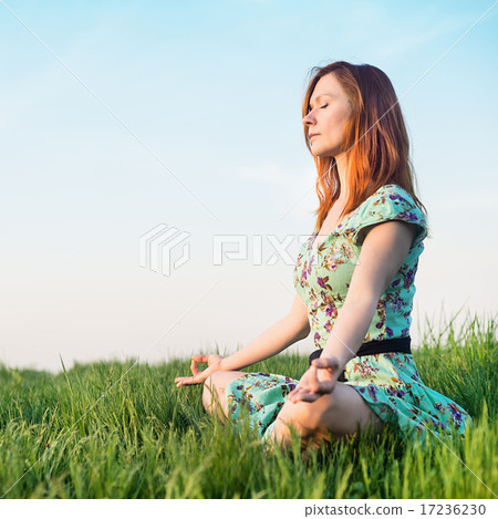 Pretty woman meditate in the park Pretty woman meditate in the park 17236230