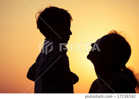 Mother and son playing on the beach at the sunset time. Mother and son playing on the beach at the sunset time. 17236592