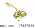 Lots of cardamom pods on wooden spoon 17237626