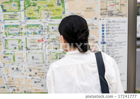 A woman tilting his head looking at the guide plate 17241777