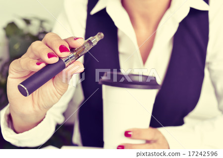 young woman vaping from an electronic cigarette 17242596