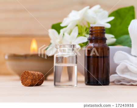 Aroma oil bottles arranged with jasmine flowers Aroma oil bottles arranged with jasmine flowers 17243938
