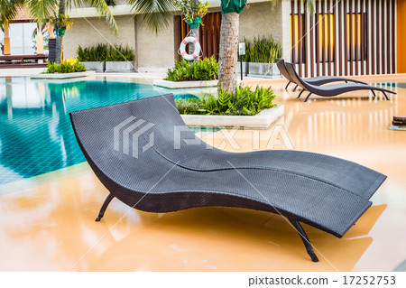 Beach chairs near swimming pool in hotel 17252753